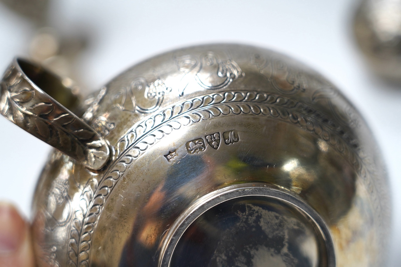 An Edwardian silver replica of a Mycenaean cup, Nathan & Hayes, Chester, 1912, height 62mm, together with a late Victorian silver mounted scent flask, two silver condiments and an Indian white metal box and cover. Condit